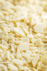 Grated white chocolate. Chocolate flakes background.