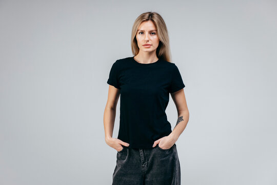 Stylish Blonde Girl Wearing Black T-shirt Posing In Studio