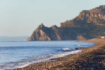 pebble beach panorama of the Sicilian coast near Taormina, Messina on a beautiful autumn morning,