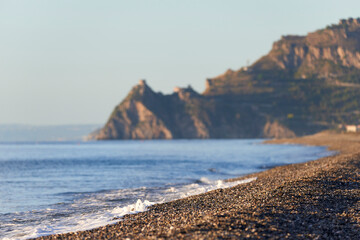pebble beach panorama of the Sicilian coast near Taormina, Messina on a beautiful autumn morning,