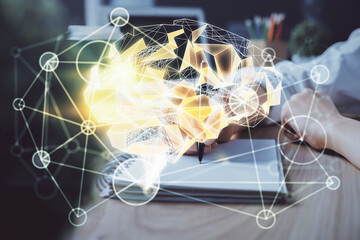 Multi exposure of writing hand on background with brain hologram. Concept of learning.