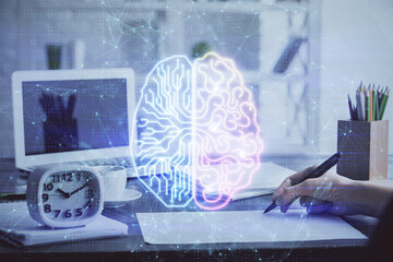 Obraz premium Multi exposure of writing hand on background with brain hologram. Concept of learning.
