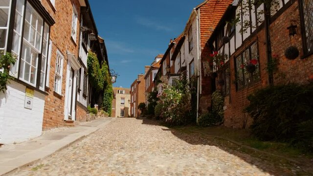Low angle POV walk along the picturesque Mermaid Street in Rye, East Sussex, UK with impressive Tudor houses and cobblestone
