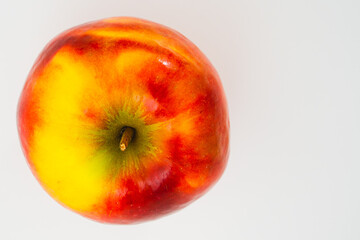Top view of an apple on a white background. Place for an inscription. Copy space. Healthy, grown food. Vegetarian and raw food diet.