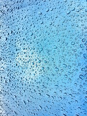 Close up texture water droplets raindrop on beautiful blue metallic background image for abstract background.