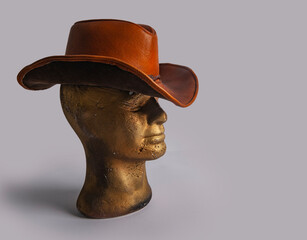 Gold color mannequin with cowboy hat