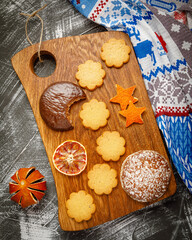 Christmas still life with homemade gingerbread cookies on wooden board