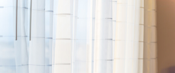 Panoramic white curtain with backlit morning light at window facing room in American hotel