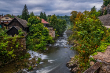 Fototapeta na wymiar Rastoke Village near Slunj in Croatia, old water mills on waterfalls of Korana river. August 2020, long exposure picture.