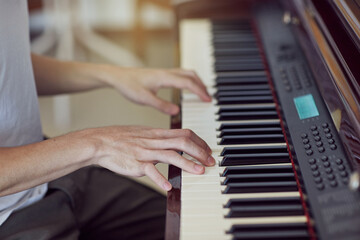 Obraz na płótnie Canvas Hands of white shirt pianist playing on piano keyboard.