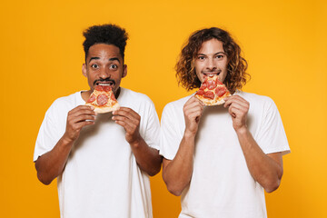 Portrait of a two hungry young men eating pizza isolated