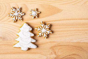 Fototapeta na wymiar Christmas gingerbread cookies on a wooden background with copy space.