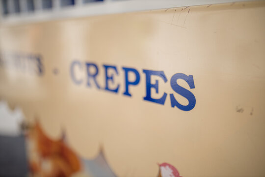 Landscape view of the word Crepes on the signboard of a sweet snacks stand
