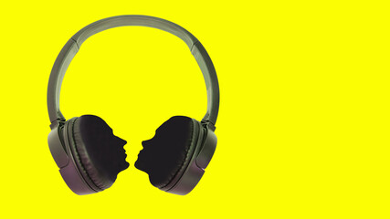 Fototapeta na wymiar Headphones with silhouettes of a man and a woman. Concept for design. Isolated yellow background. Copy space