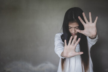 Woman's hand extended signaling to stop useful to campaign against violence, gender or sexual...