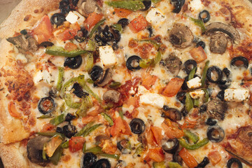 pizza with mushrooms, olive and other various products, close up