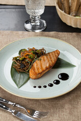 Grilled salmon steak fillets with pasta on the table at restaurant