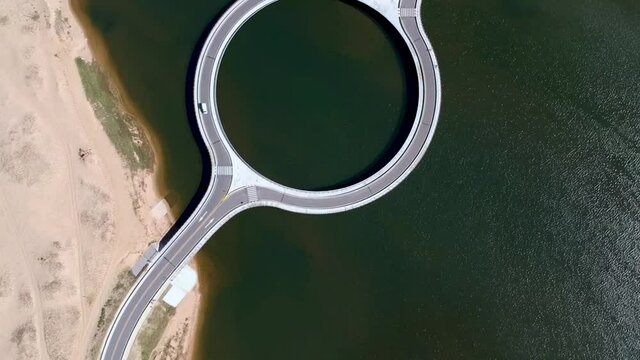 Drone footage of a car moving a round bridge in Garzon, Maldonado, Uruguay.