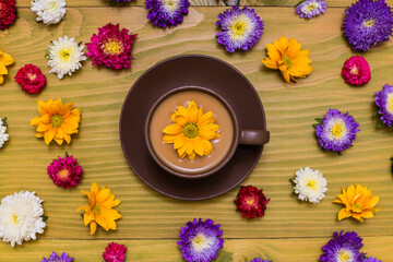 Obraz na płótnie Canvas Image of cup of coffee with beautiful flowers on wooden background.