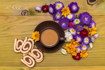 Image of cup of coffee, cookies and  beautiful flowers on wooden background.