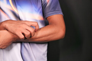 man suffering from itching skin, close up.