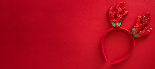 Colorful reindeer antlers headband. Holiday costume detail. Creeting card. Horn of a Christmas deer. New Year decoration on hair. Top view, flat lay, banner