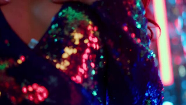 Young woman touching breast at party. Sexy girl making movements in nightclub