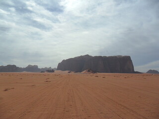 Hiking in the red desert sandcliffs and dunes of Wadi Rum in Jordan, Middle East