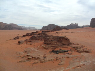 Fototapeta premium Hiking in the red desert sandcliffs and dunes of Wadi Rum in Jordan, Middle East