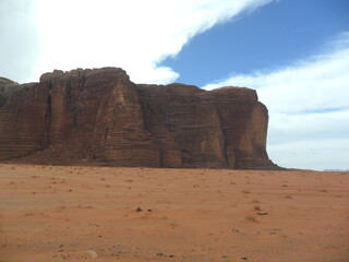 Hiking in the red desert sandcliffs and dunes of Wadi Rum in Jordan, Middle East