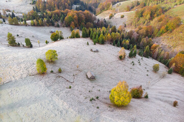 Autumn scene in Romania with hoarfrost over the Carpathian hills, in Transylvania village