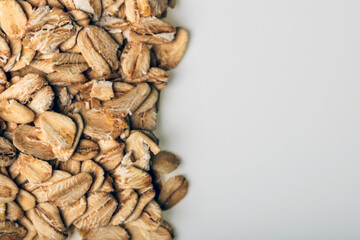 Oats on white background. Close-up photography, white and grey gradient, space for text.