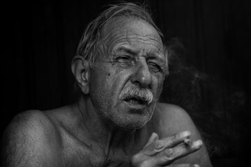 Fototapeta na wymiar portrait of a smocking old man