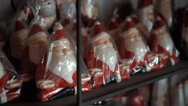 Christmas wooden toys of santa claus sits in the house in plastic packaging