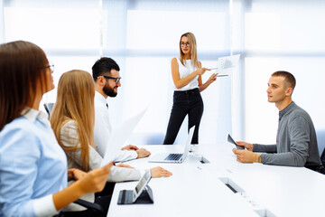 Successful team leader leading business meeting with colleagues, business and entrepreneurship concept