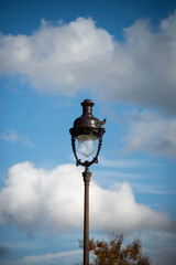 Fototapeta na wymiar Closeup of street light from Montmartre quarter in Paris on beautiful blue cloudy sky background