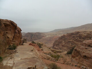 Hiking in the red sand dunes and cliffs of Wadi Rum and Petra archeological site in Jordan, Middle East