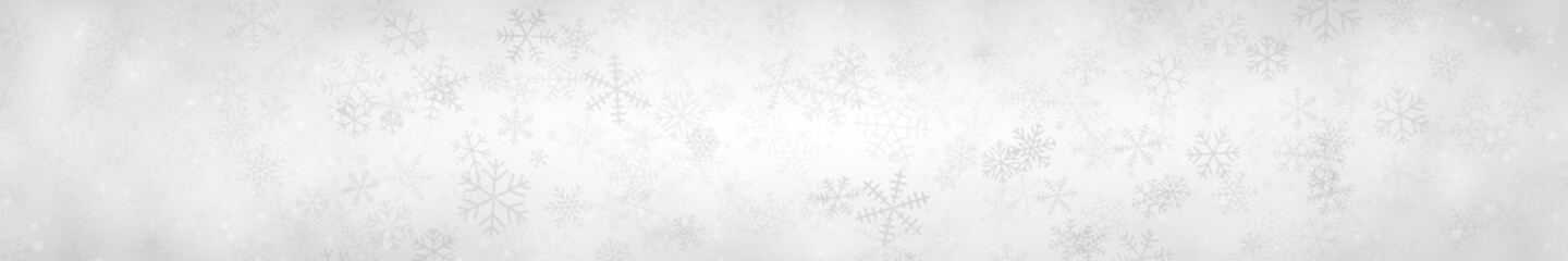 Christmas banner of snowflakes of different shapes, sizes and transparency on gray background