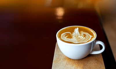 Panorama Cup of hot latte art coffee on wooden table