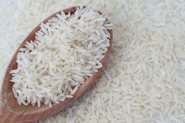 White rice on wooden spoon. Raw rice.  