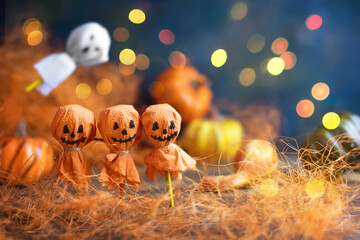 Four cheerful round lollipops converted into a pumpkin and ghost