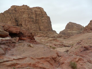 Fototapeta premium Exploring the archeological site of Petra and the red sandstone landscapes in Jordan