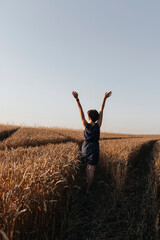 Naklejka na ściany i meble girl in a wheat field