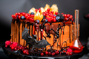 Cakes and pastries for Halloween celebration, holiday design with ghosts, bats and witchcraft potions on a black background. All saints' day confectionery.