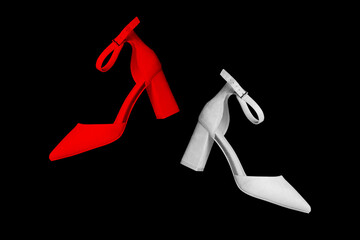 Colored female high-heeled shoes isolated on black background. Creative minimal style