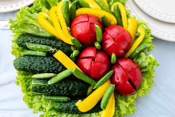 Cutting vegetables. Tomatoes, cucumbers, peas, peppers, lettuce leaves