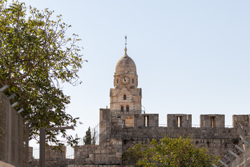 Fototapeta na wymiar The city wall and the upper part of the Franciscan monastery near the Armenian quarter in the old city of Jerusalem, Israel