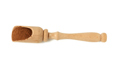 brown ground cinnamon in a wooden spoon