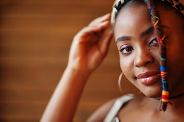 Close up porrtrait of lovely african american woman with dreadlocks in leopard outfit at cafe. Beautiful cool fashionable black young girl indoor.