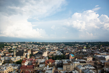 Panorama of the city of Lviv under thick clouds with a sunny glimpse.